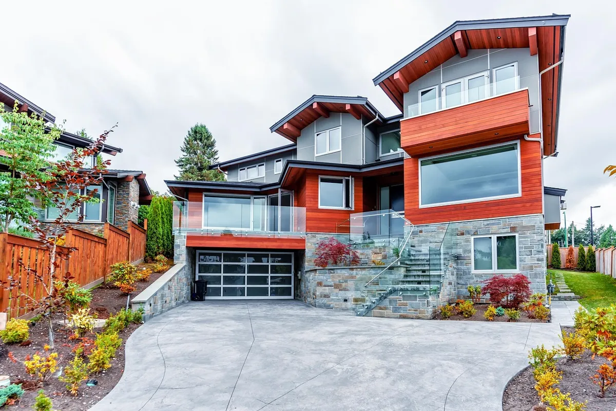 Modern hillside house with a glass-panel garage door